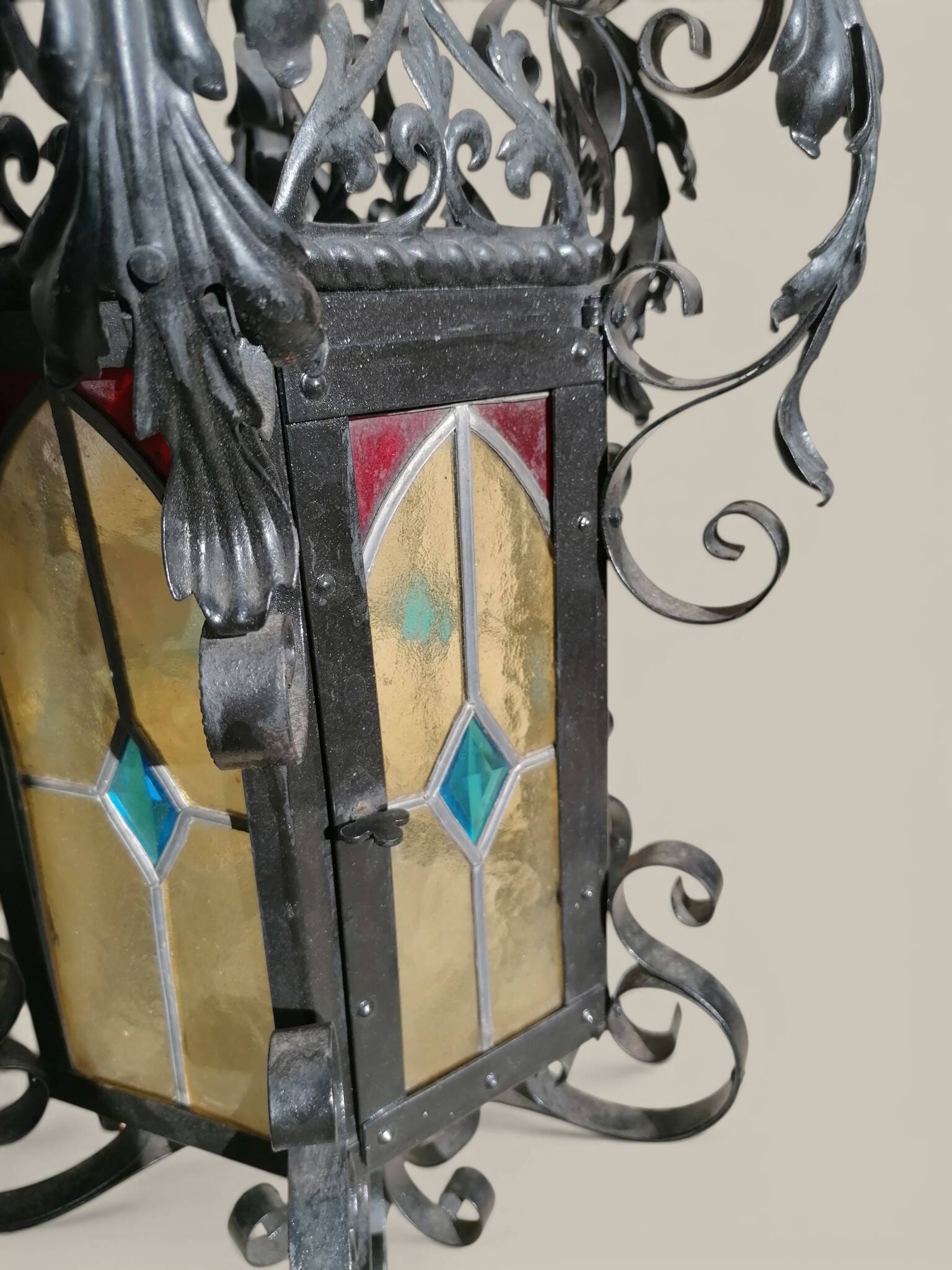 Black wrought iron lantern with stained glass. Medieval, Gothic decoration.