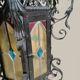 Black wrought iron lantern with stained glass. Medieval, Gothic decoration.