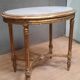 Oval coffee table in gilded wood in the Louis XVI style.