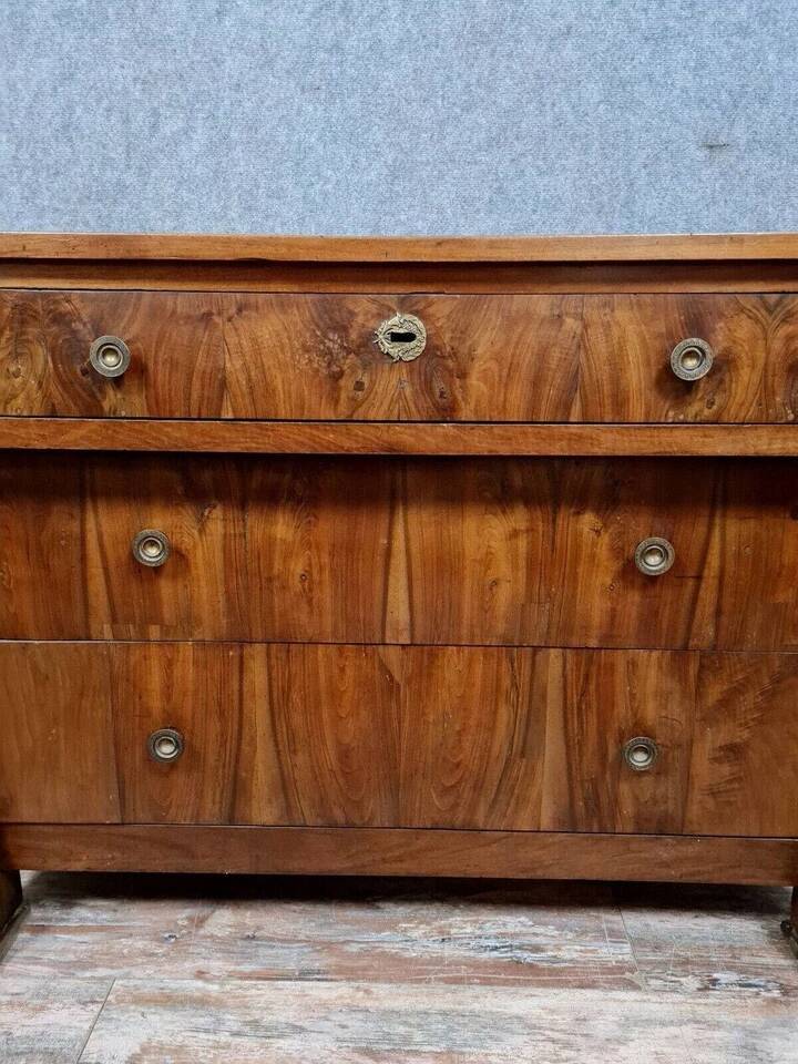 Empire period chest of drawers in walnut and gilded bronze circa 1810-1820