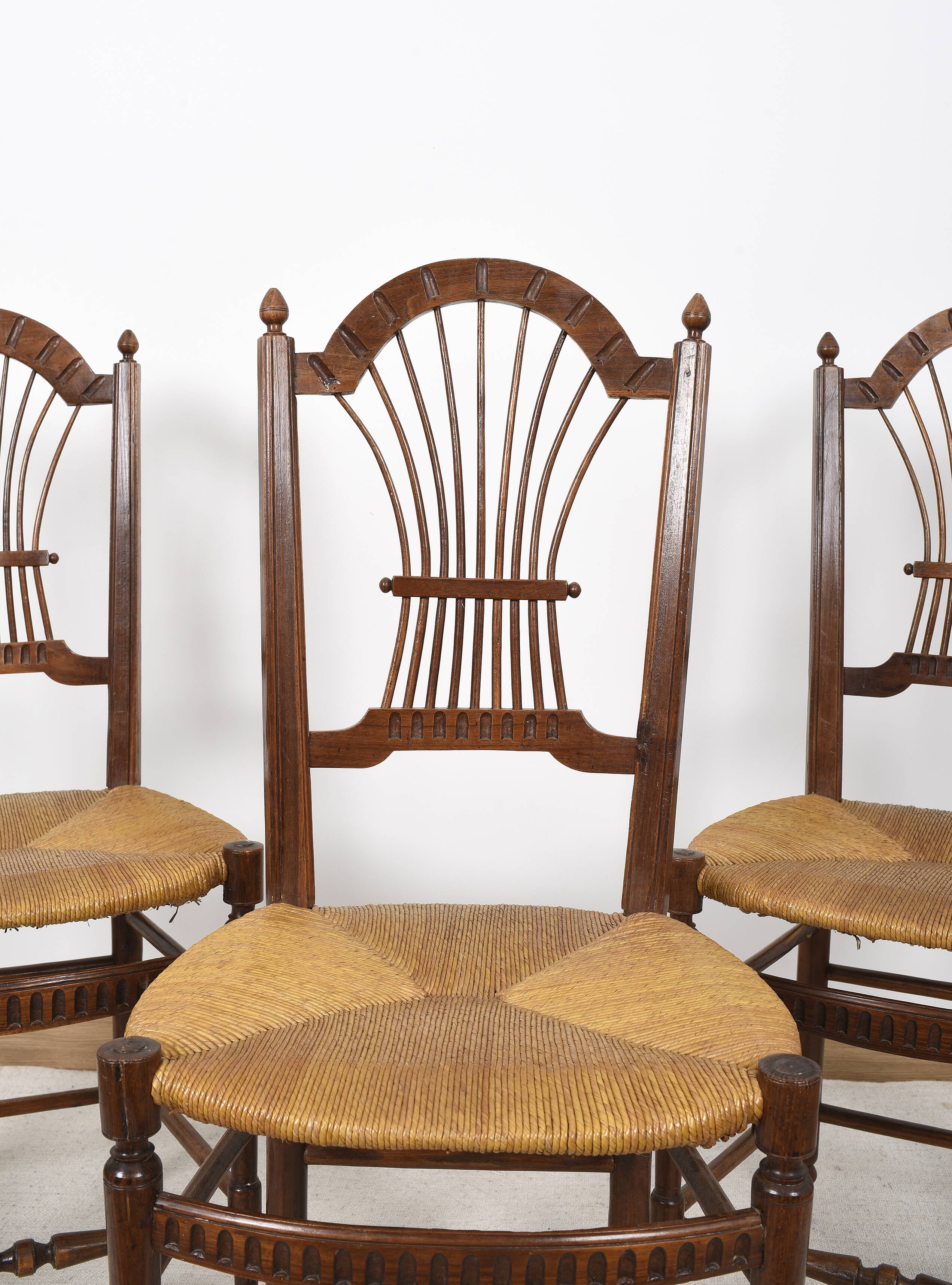 3 wooden and straw chairs, decorated with a sheaf of wheat.