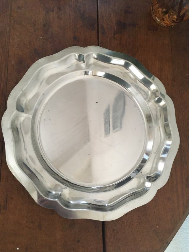 Two matching round dishes in stainless steel