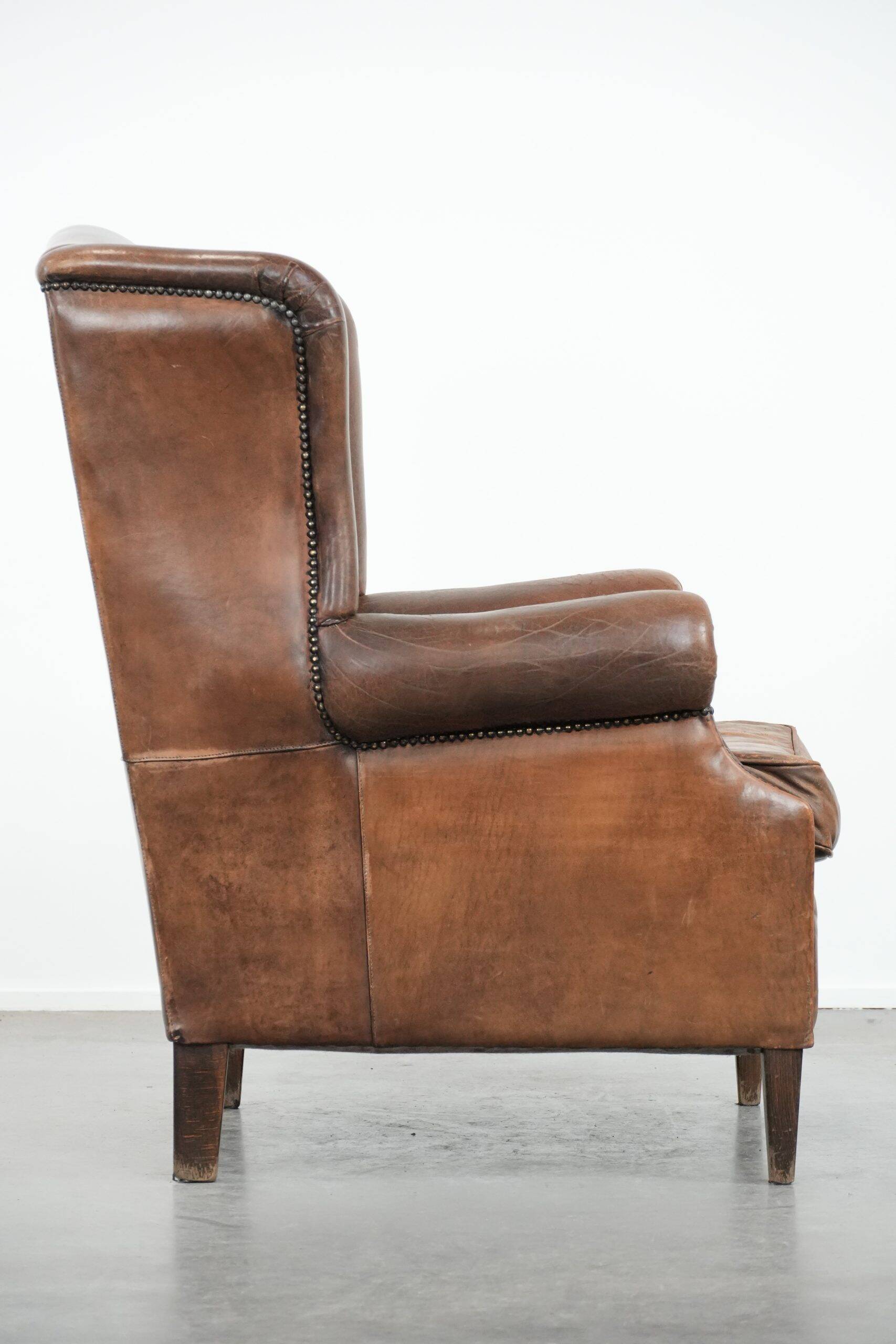 Vintage wingback armchair made of sheepskin leather with beautiful colours