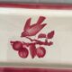 Cake dish bird pattern on its branch in red and white tones