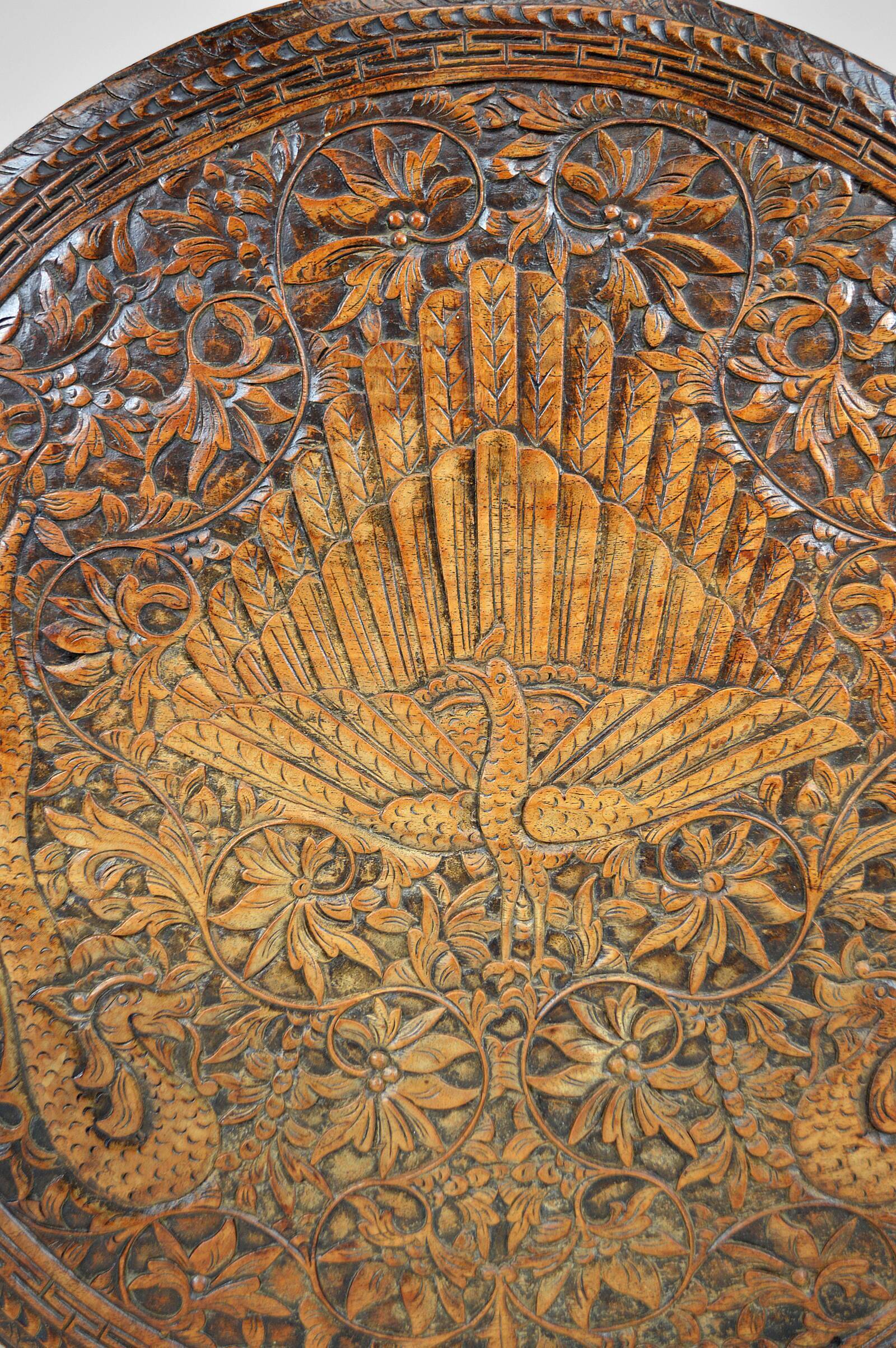 Asian coffee table carved with dragons and peacocks, Indonesia, early 20th century