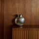 Vintage Italian vase in nickel-plated brass from the 1960s, hand-hammered relief of fruits and leaves.