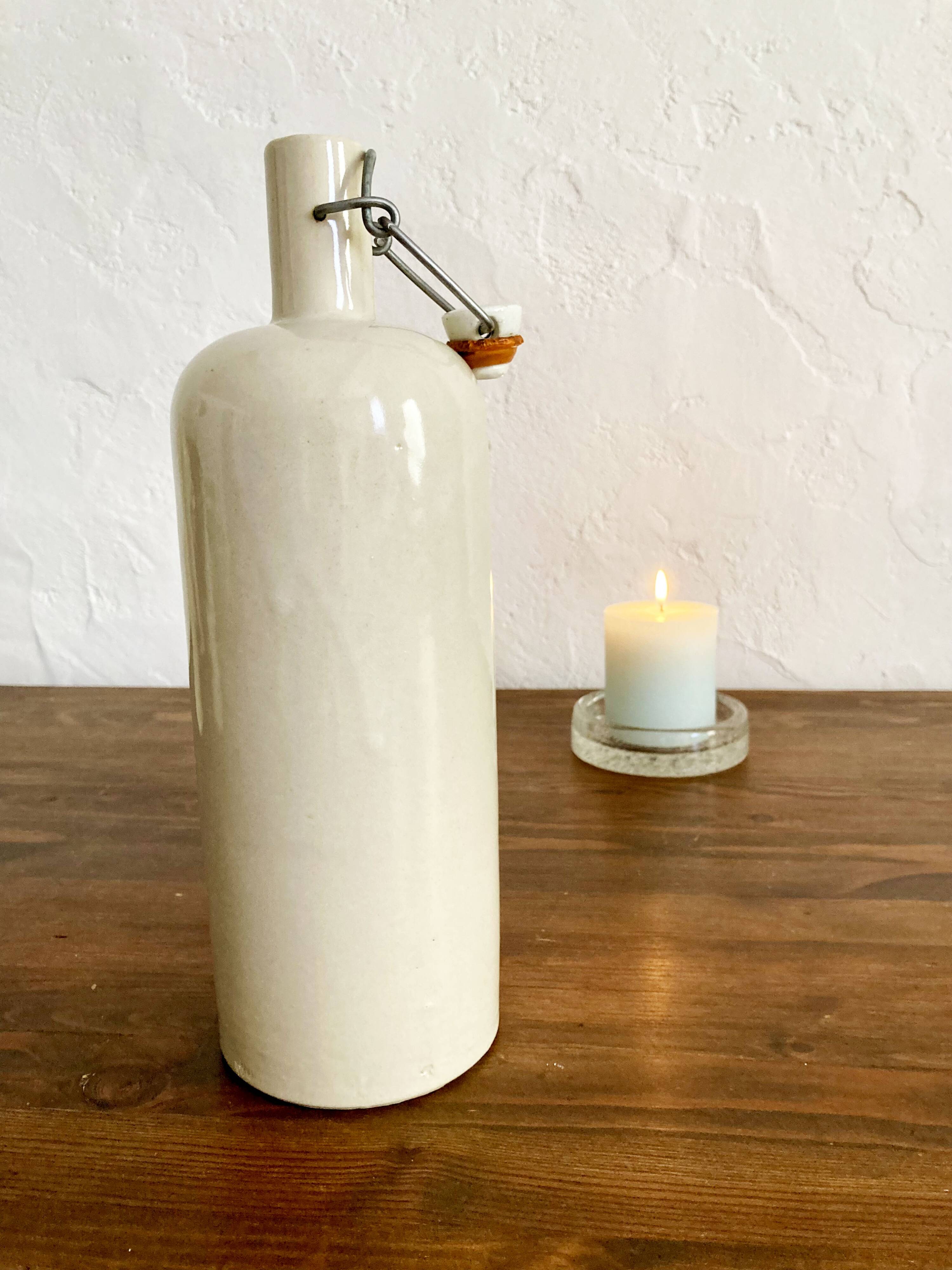 Trio of creamy white glazed stoneware bottles