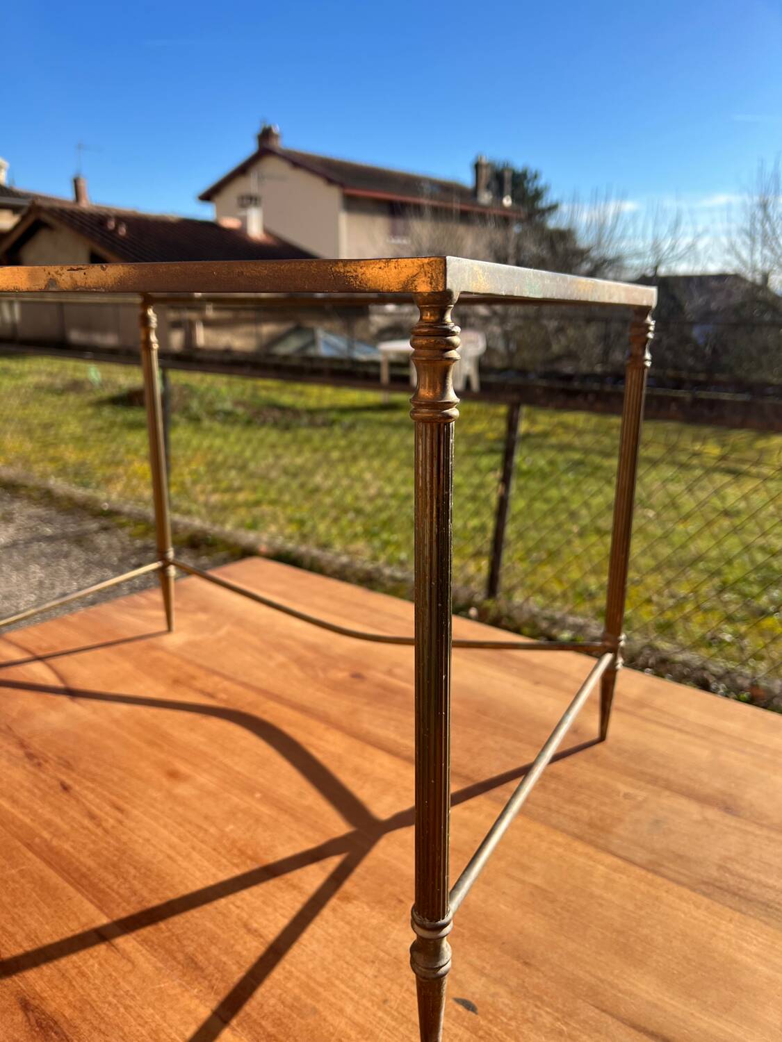 Brass side table with smoked glass.