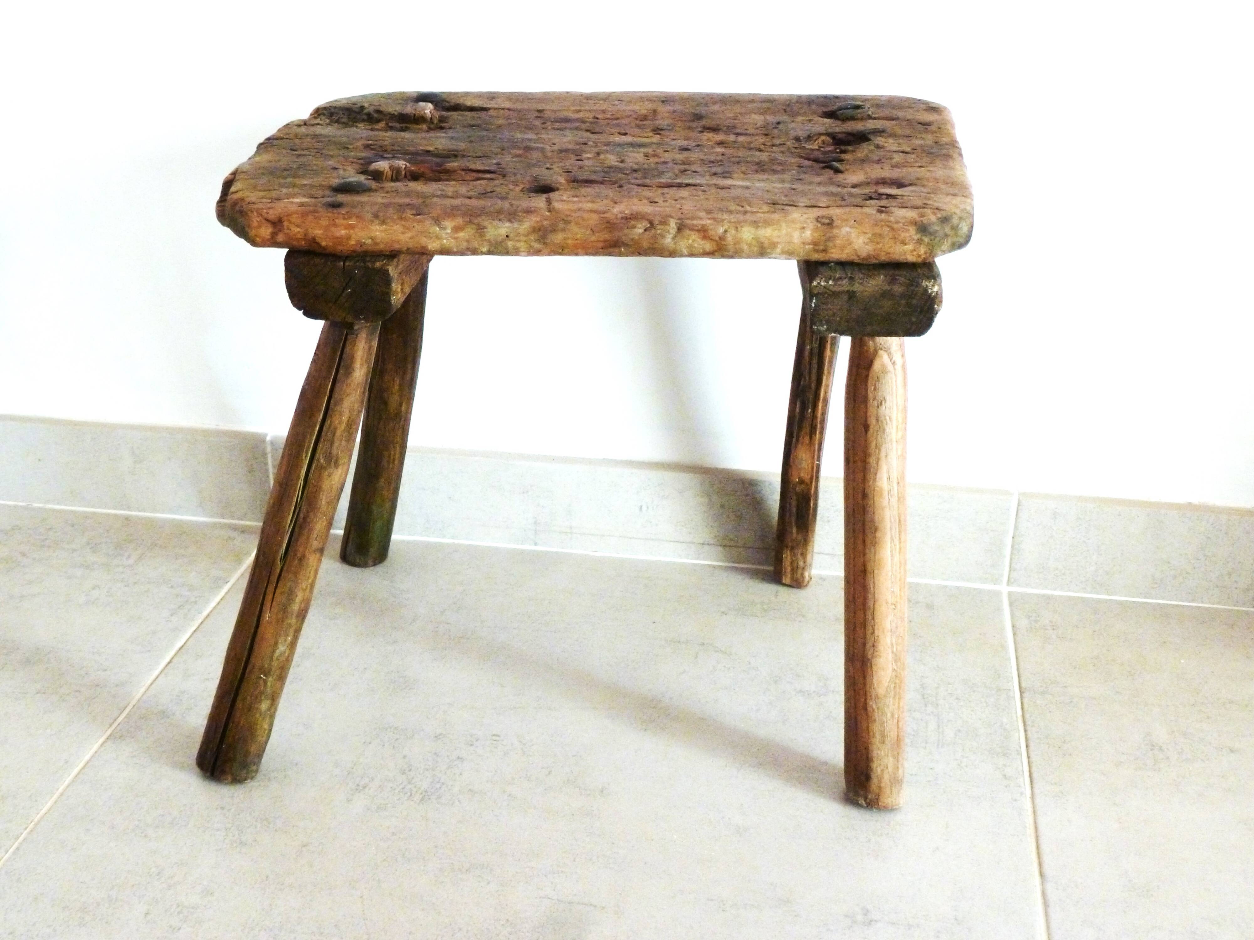 Old milking stool, old farm stool, primitive art.