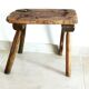 Old milking stool, old farm stool, primitive art.