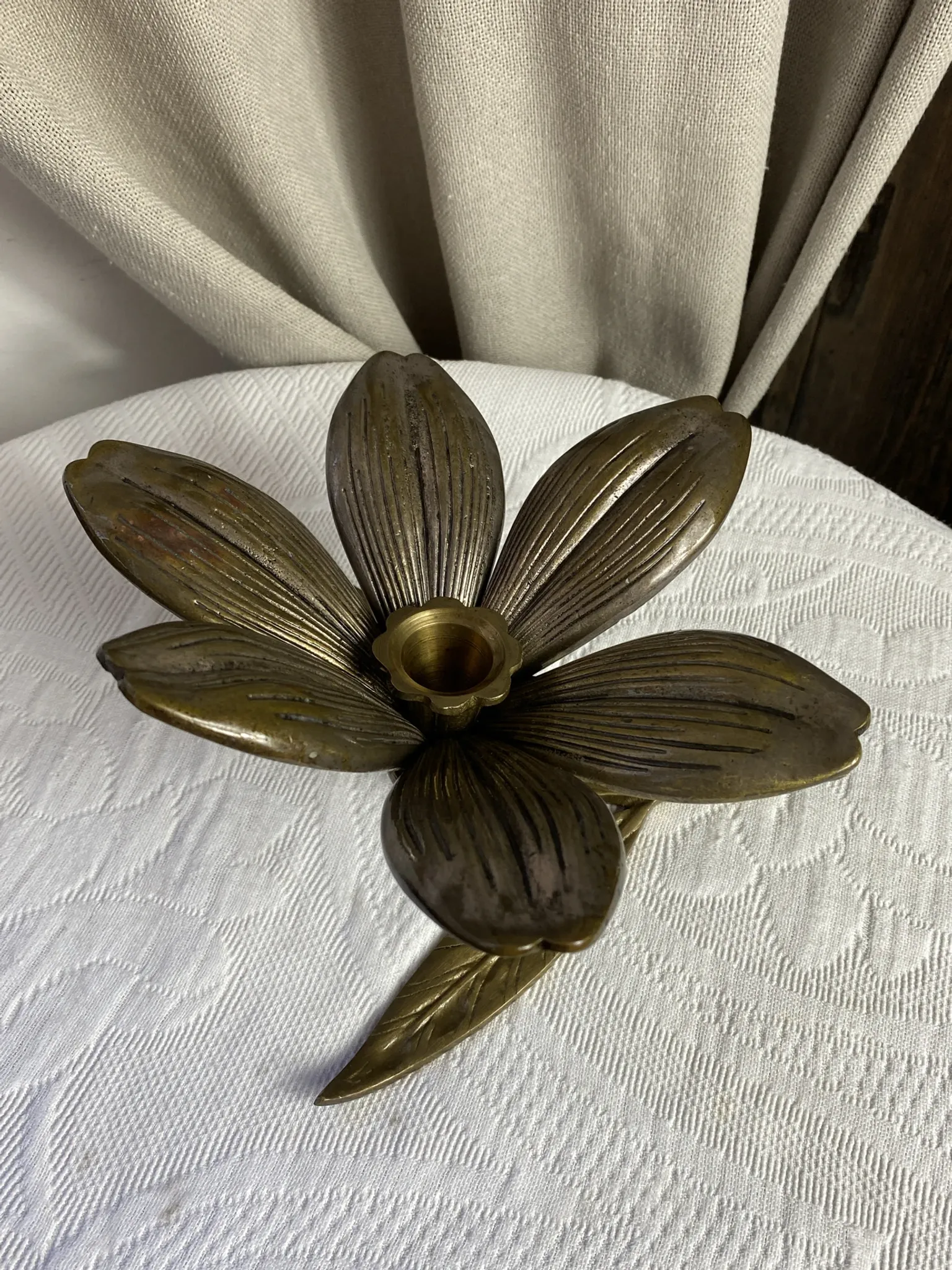 Flower candlestick and removable ashtrays in solid brass.