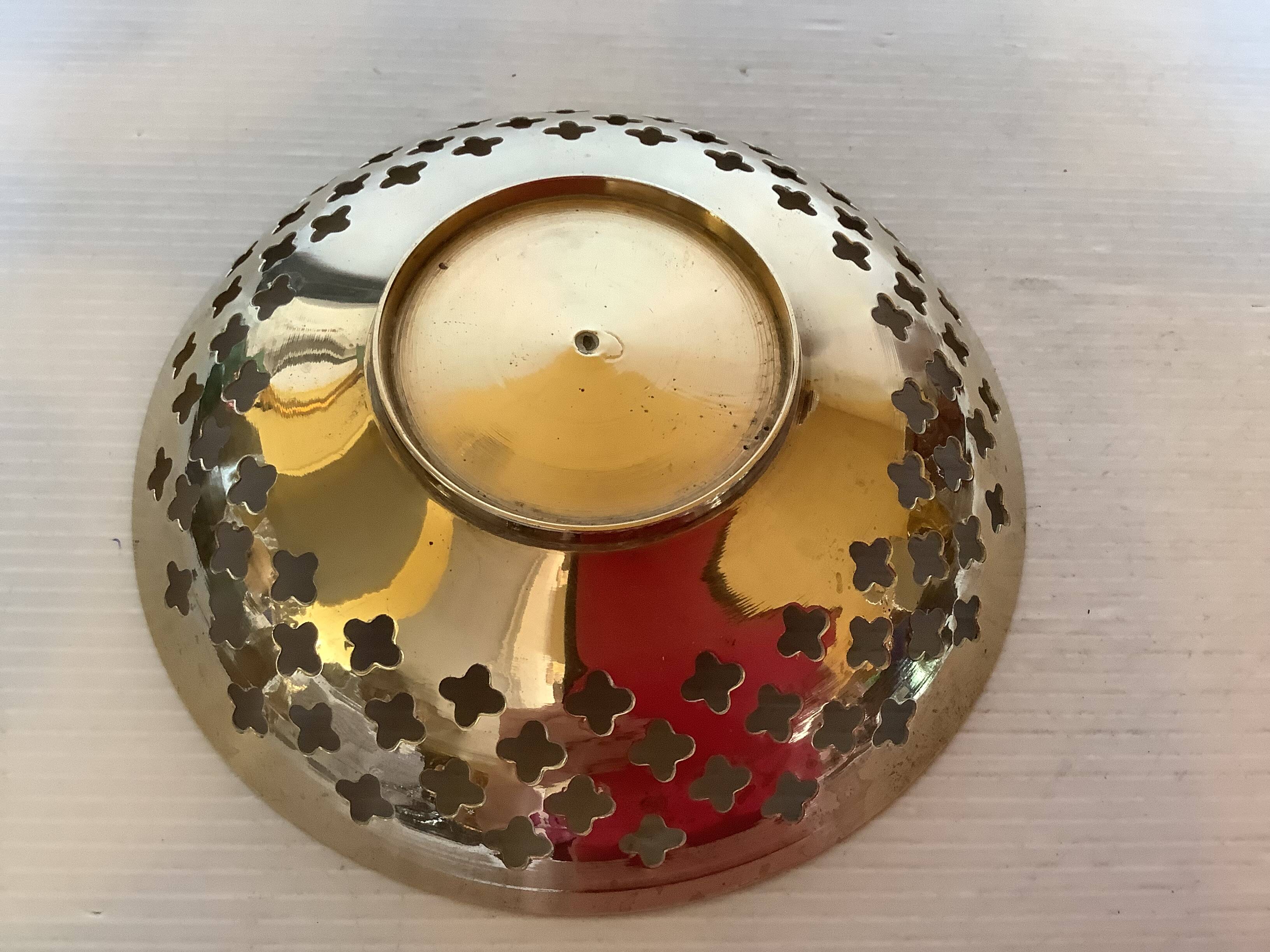 Lattice brass catchall and candlestick.