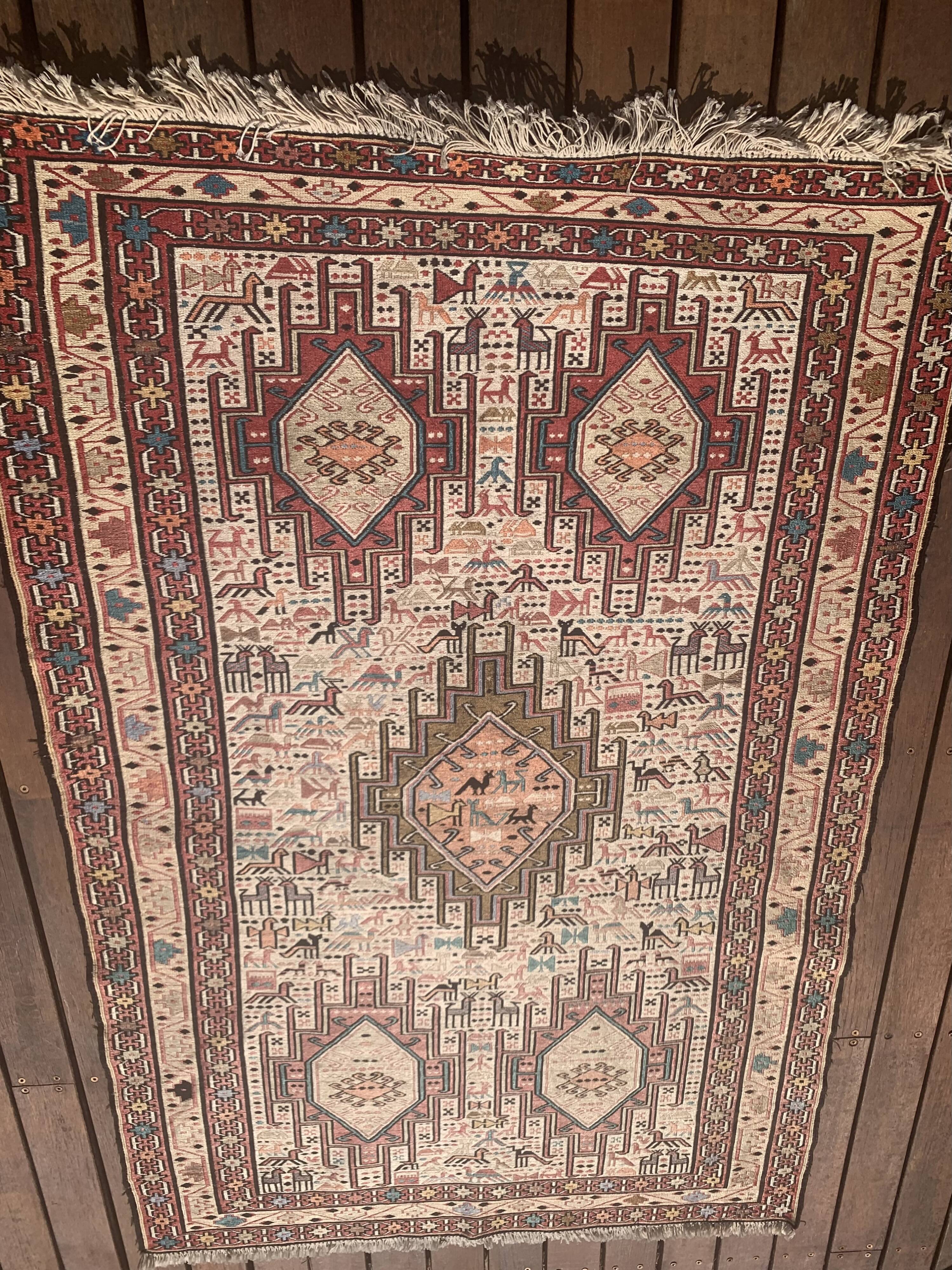 Hand-knotted silk carpet purchased in Iran – geometric and animal design –