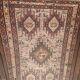 Hand-knotted silk carpet purchased in Iran – geometric and animal design –