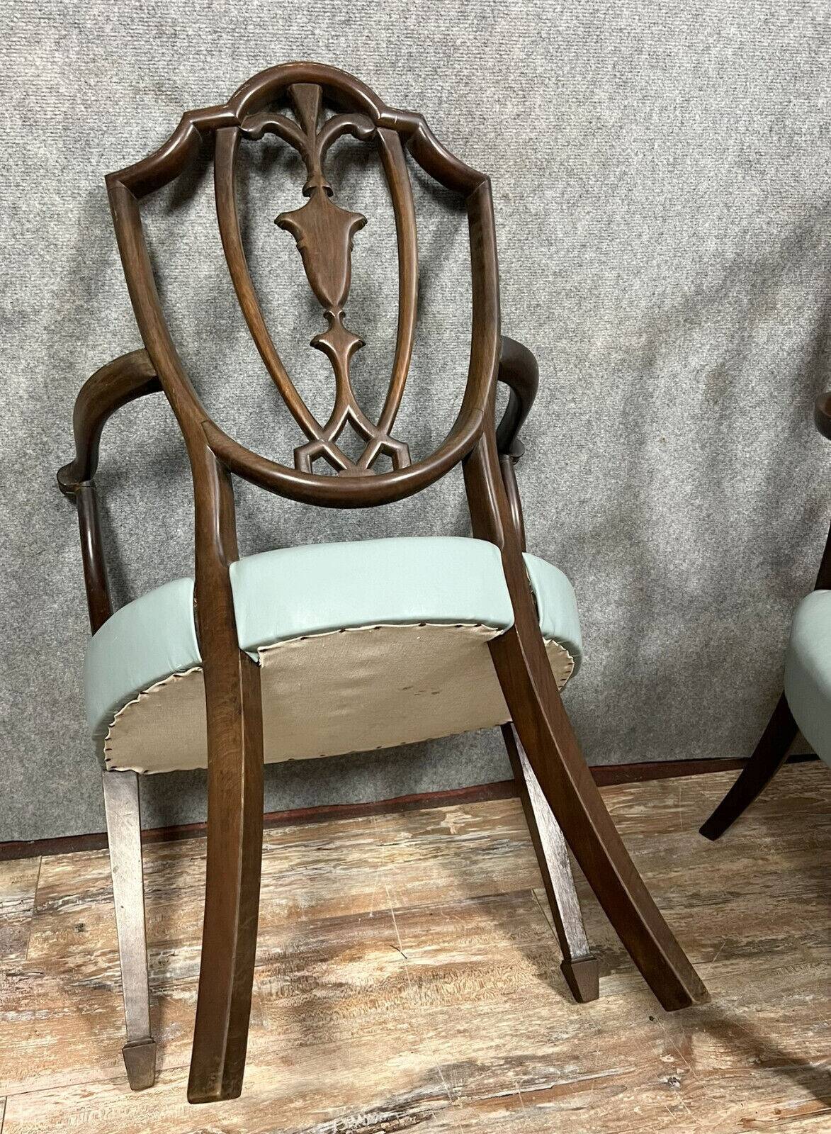 According to George Hepplewhite: pair of 19th century mahogany office armchairs