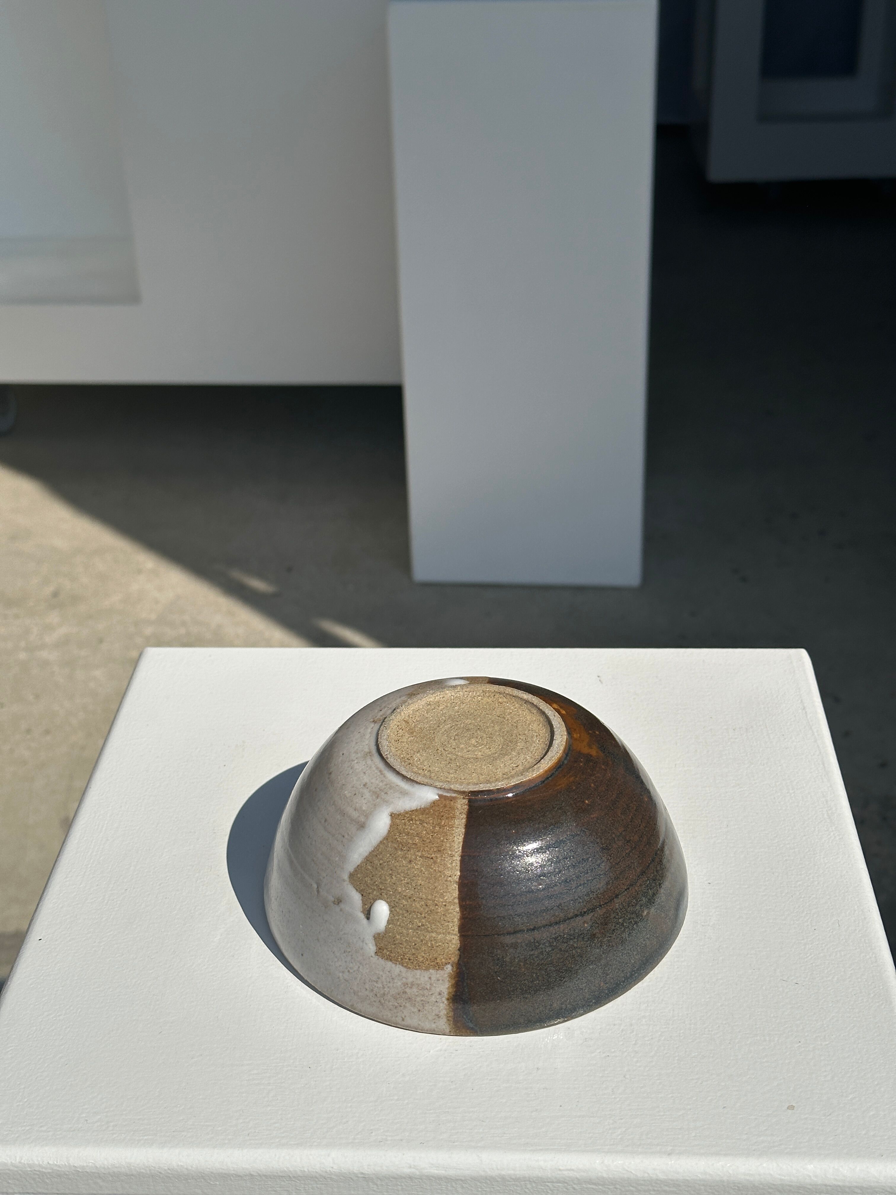 White and glossy brown two-tone ceramic bowl, matt earth