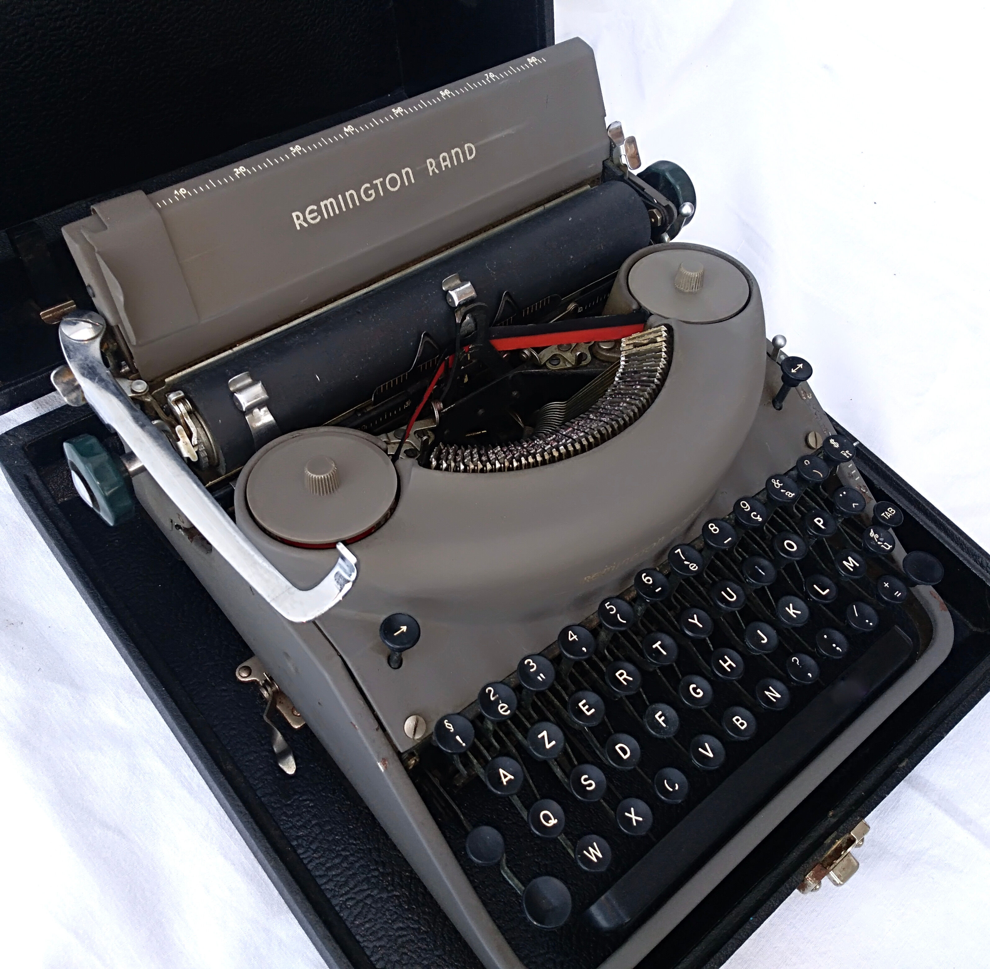 portable Remington typewriter with its suitcase and original cover