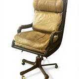 Vintage mahogany and havana leather office chair with wheels from around 1970.