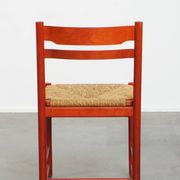 Vintage 1970s red wooden chair with a woven wicker seat