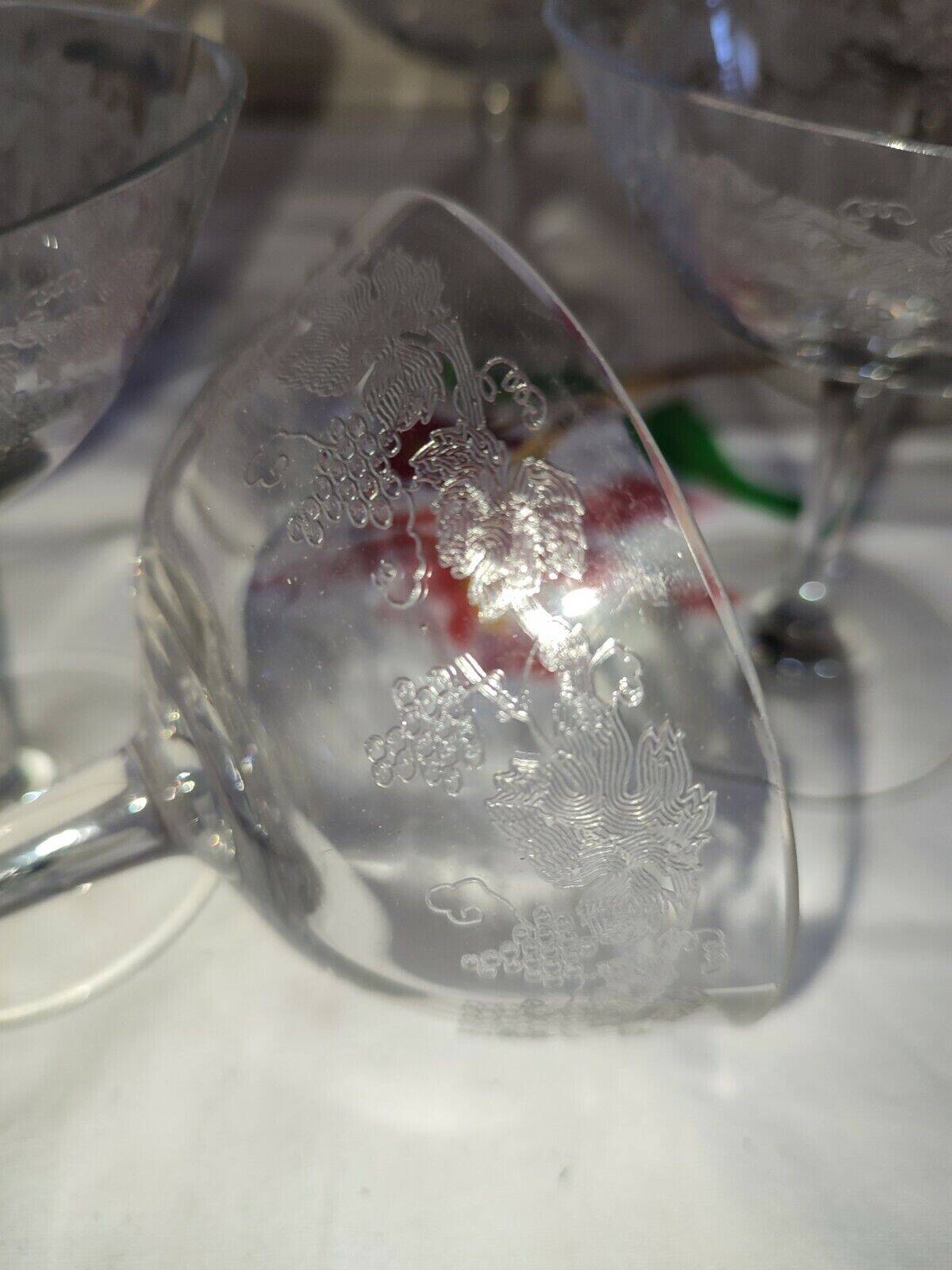 Beautiful set of seven crystal champagne glasses engraved with vine branches