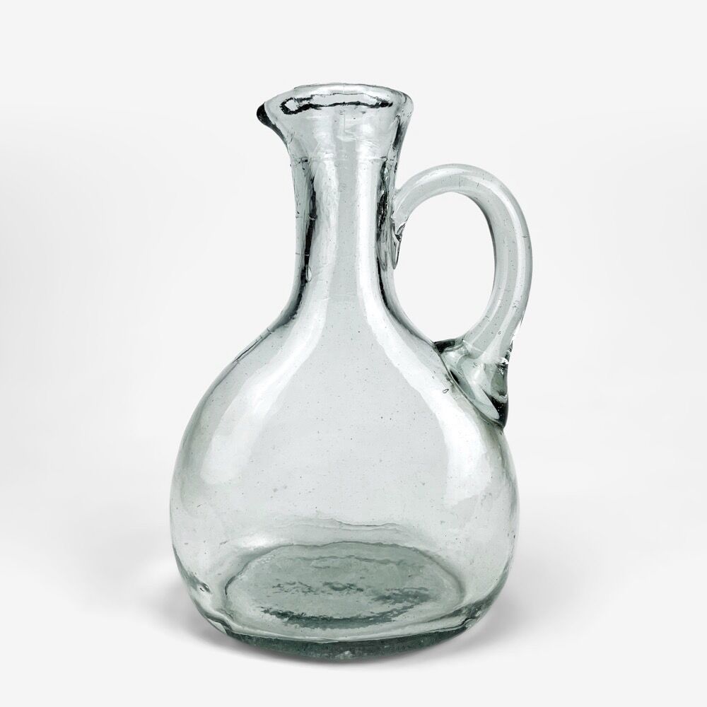 Antique water jug made of thick blown glass