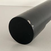 Minimalist black metal wall light with a cylindrical design, 1960s, Germany.