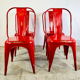 Ensemble de quatre chaises basses en acier rouge