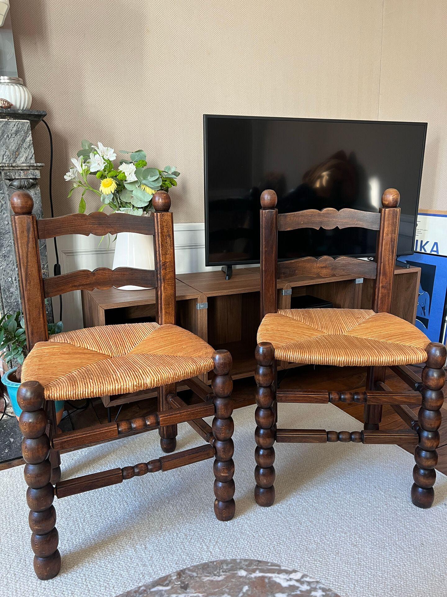 Pair of vintage armchairs with turned wood and woven rope seat.