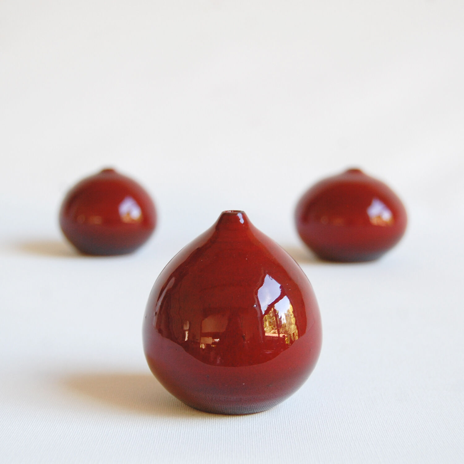 Trio of red miniature ceramics by Antonio Lampecco