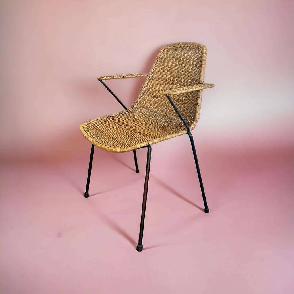 Vintage wicker chair with black steel frame and armrests