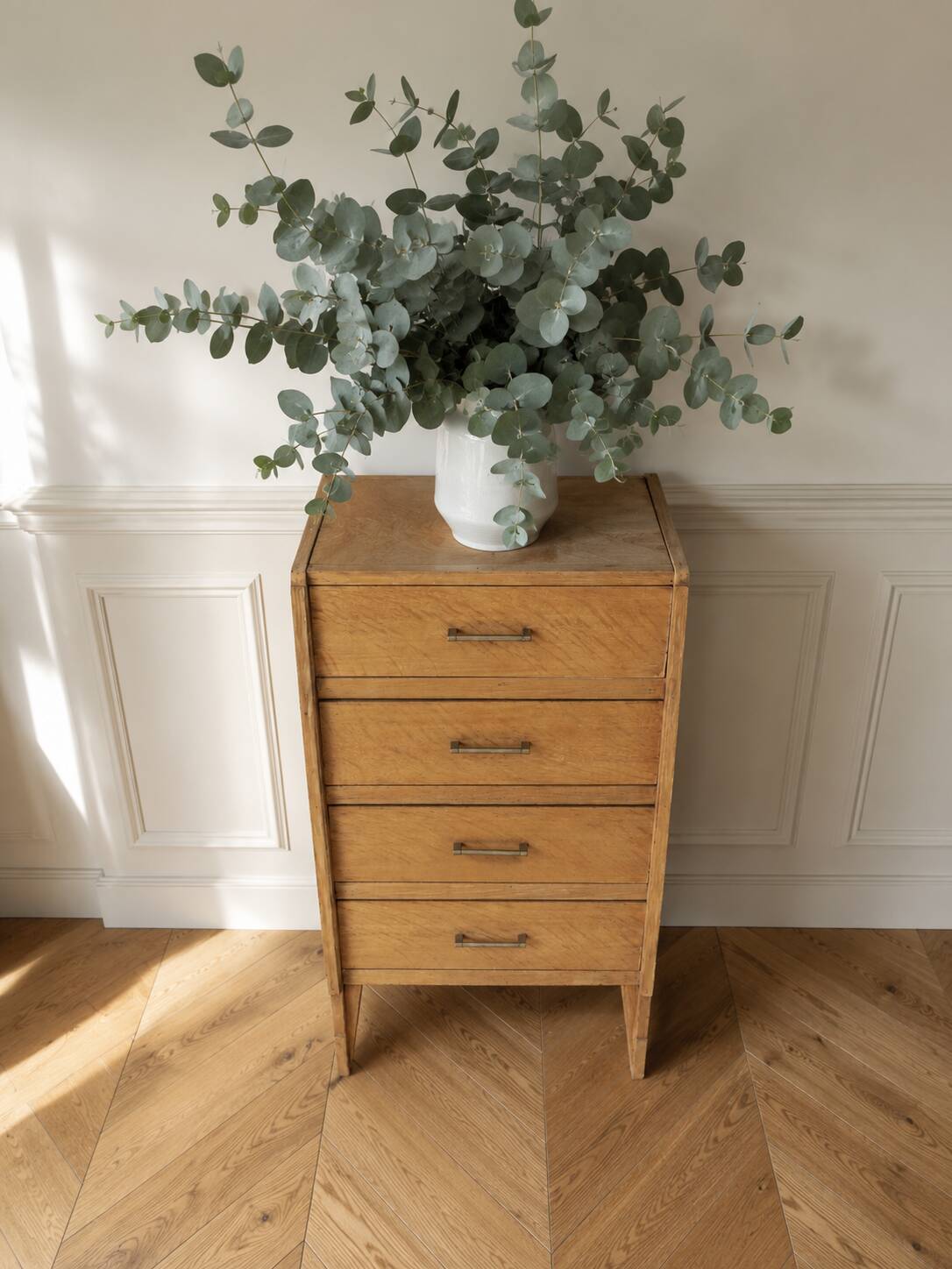 Vintage chest of drawers in raw wood.