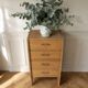 Vintage chest of drawers in raw wood.