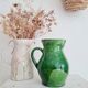 Antique green pitcher in painted terracotta