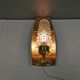 Older wall lamp in brass with hard pressed glass shade.