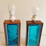 Two Swedish table lamps in solid pressed blue glass and teak wood "frame".