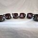 Six cups and saucers Vallauris glazed ceramic in brown and old pink.