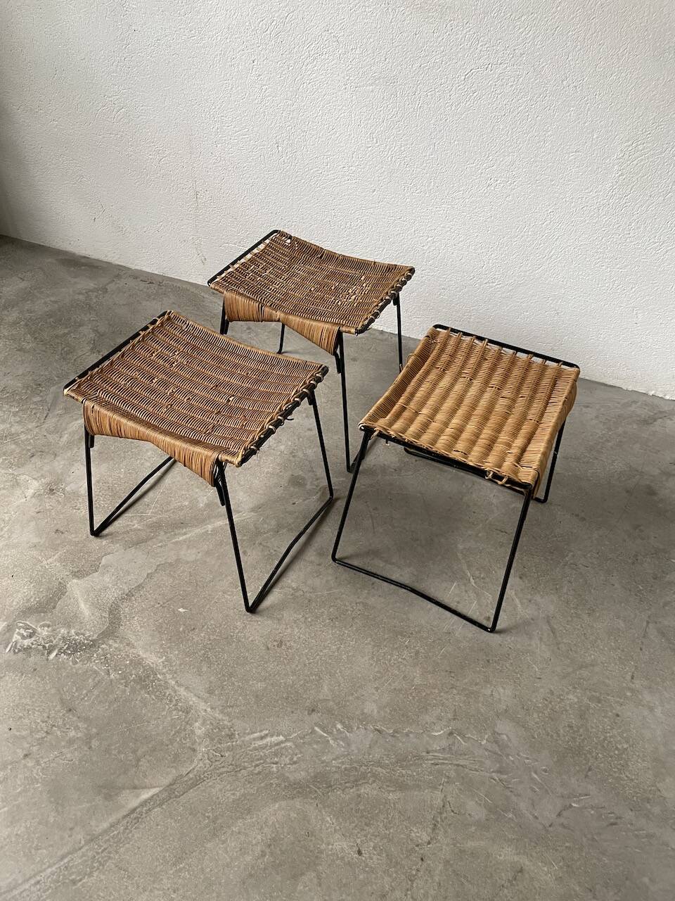 Set of three Raoul Guys wicker and metal stools