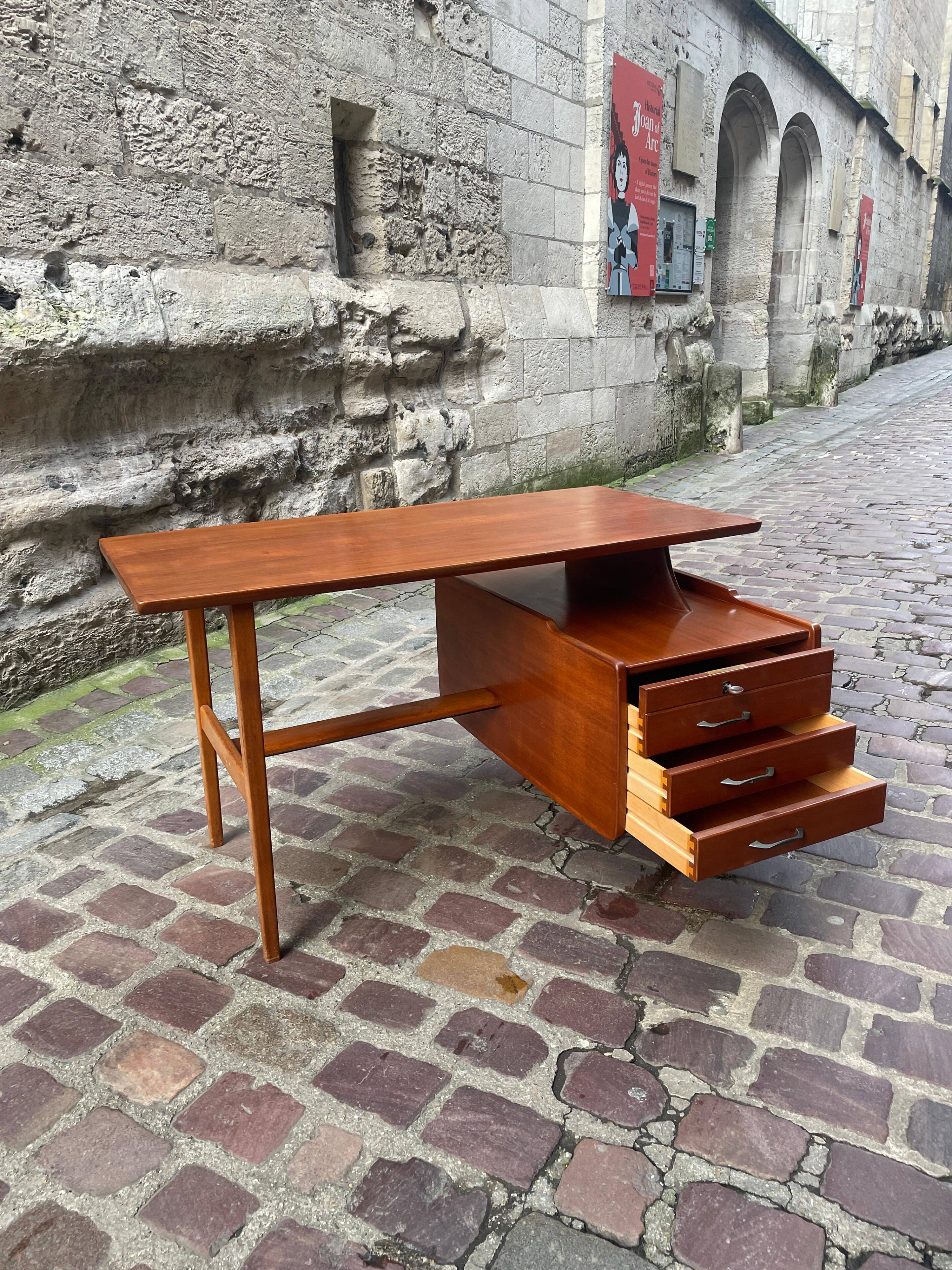 Mahogany desk with drawers by Jacques Hauville published by Bema.