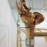 Hollywood Regency brass and glass shelf with elephant heads from the 1970s