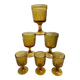 Six stemmed glasses in amber-colored molded glass