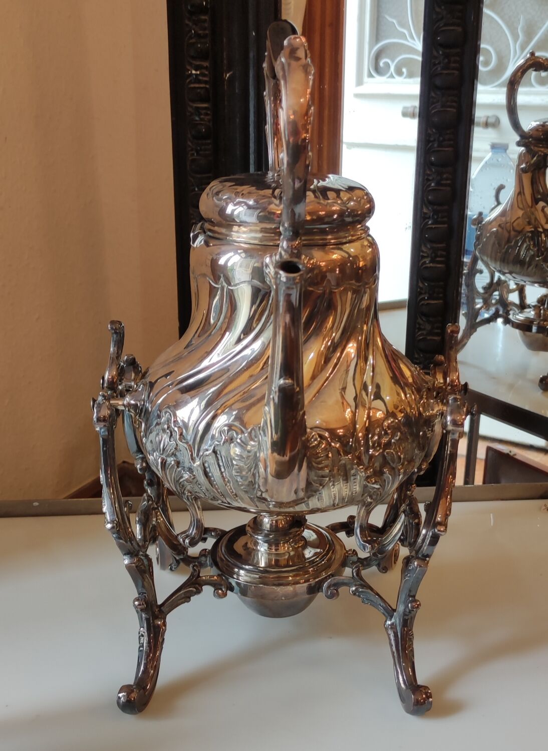 Ancient samovar tea fountain in silver metal