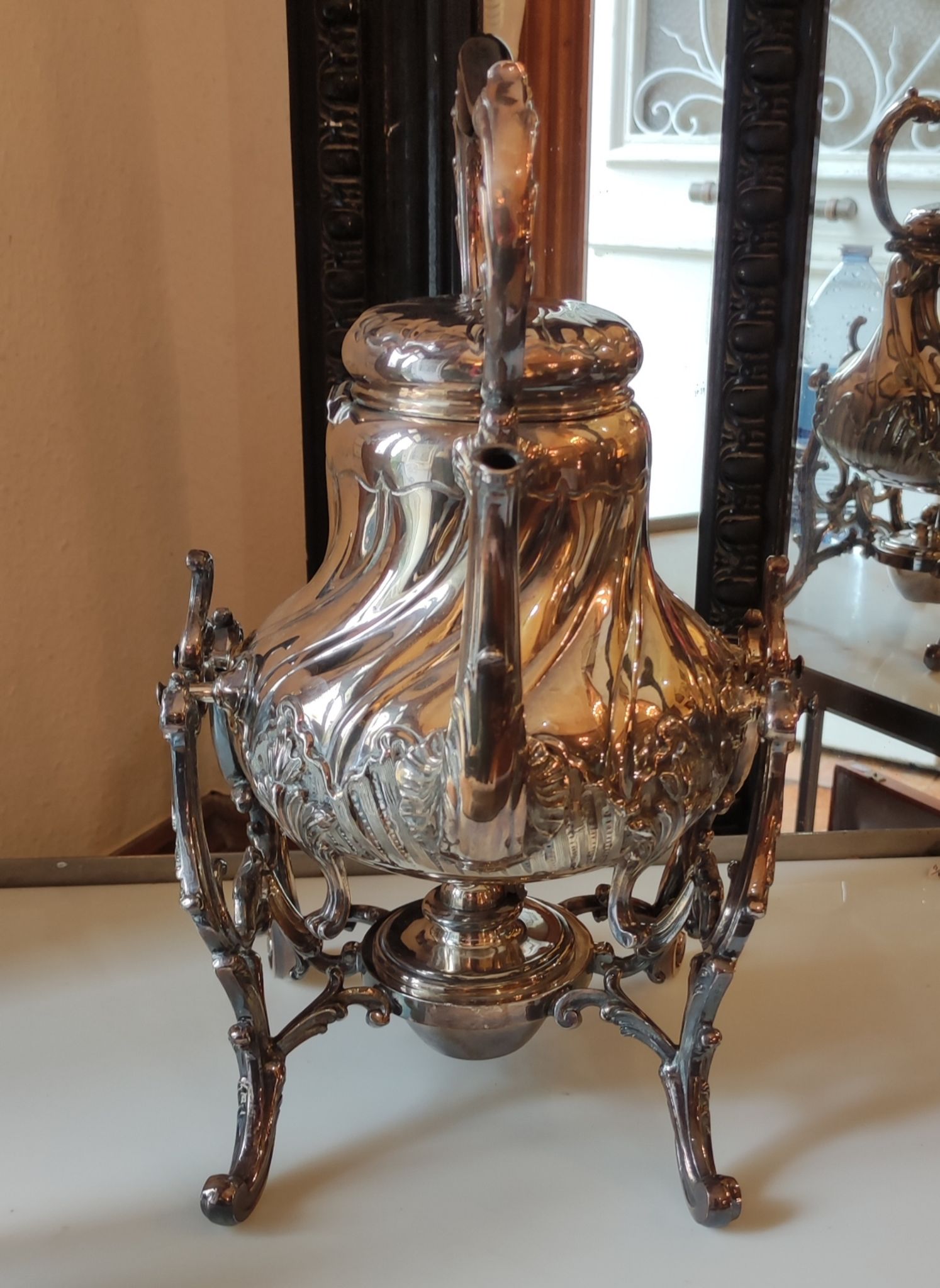 Ancient samovar tea fountain in silver metal