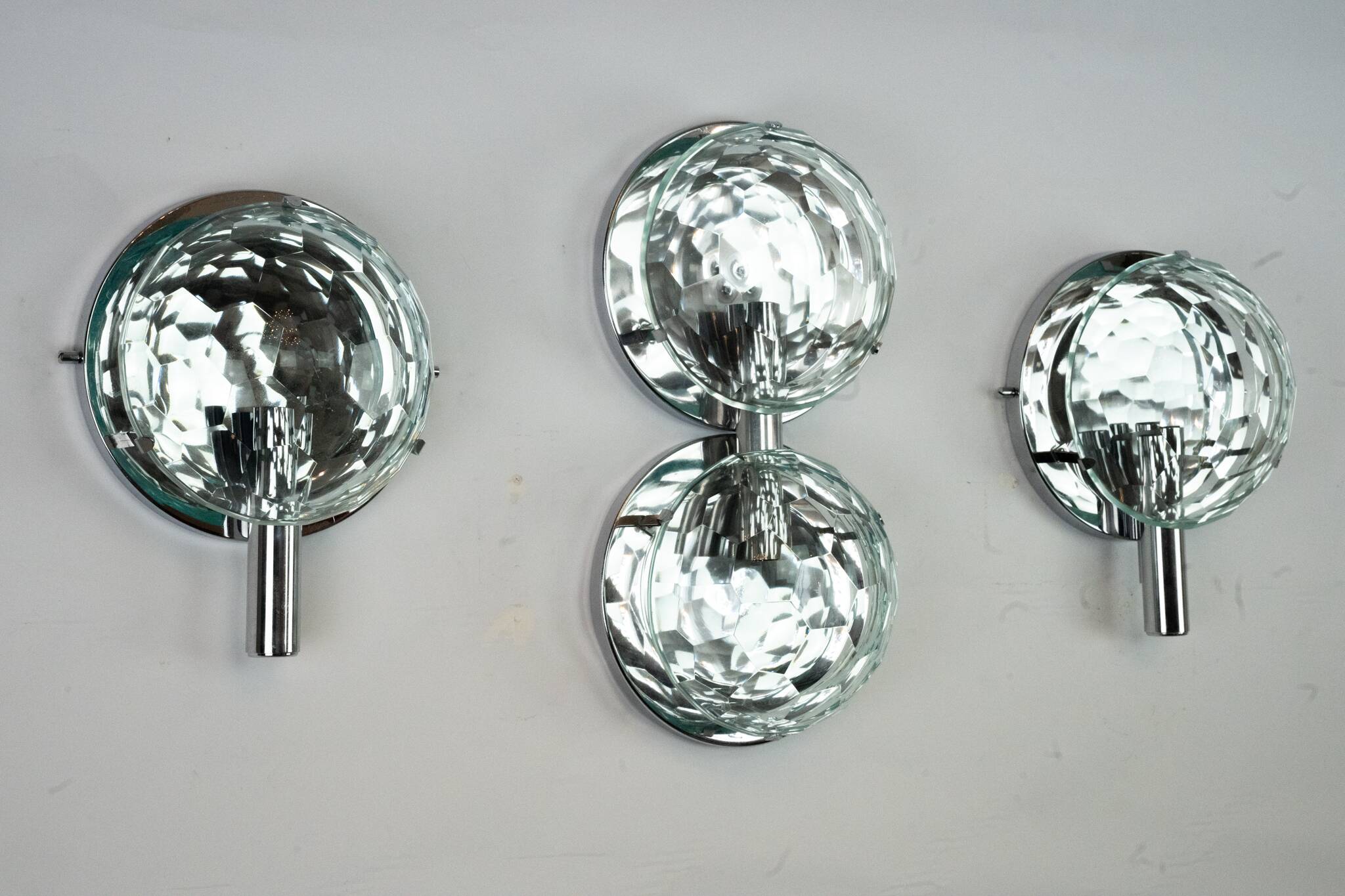 Set of three Cristal Art sconces in chrome and cut glass. Italy 1970s