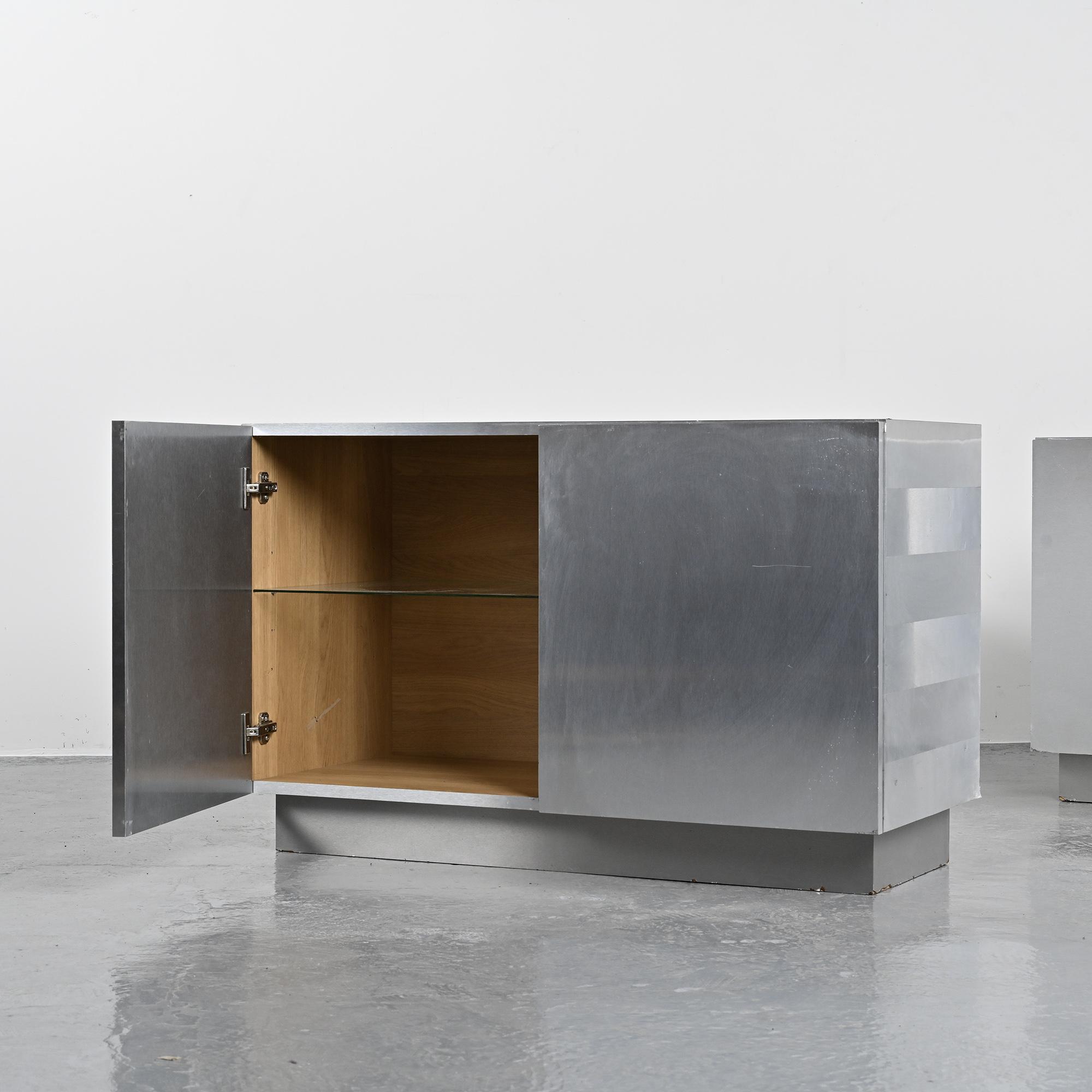 Pair of low buffets in brushed metal, French work, 1970s.