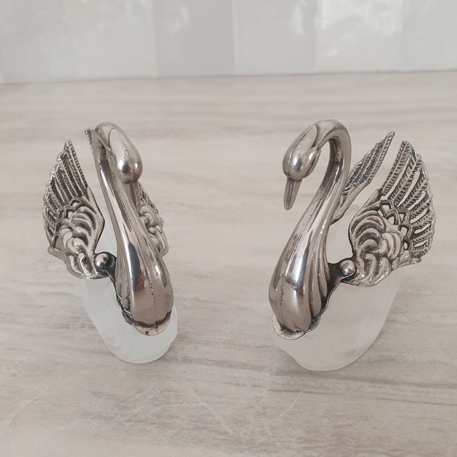 Two frosted glass swan salt cellars with silver plating.