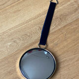 Vintage witch's eye curved mirror hangs velvet ribbon