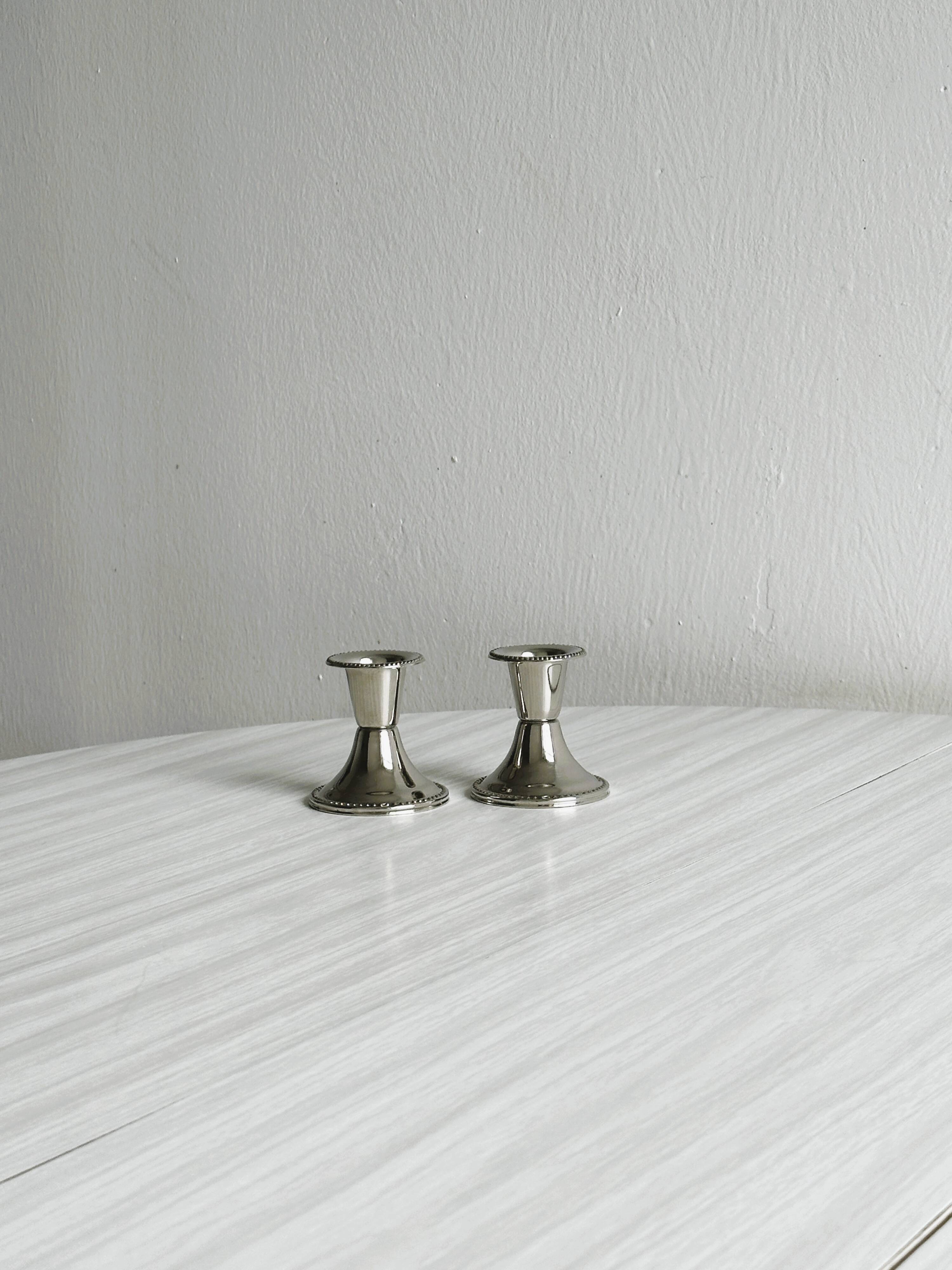 Pair of small light metal candlesticks