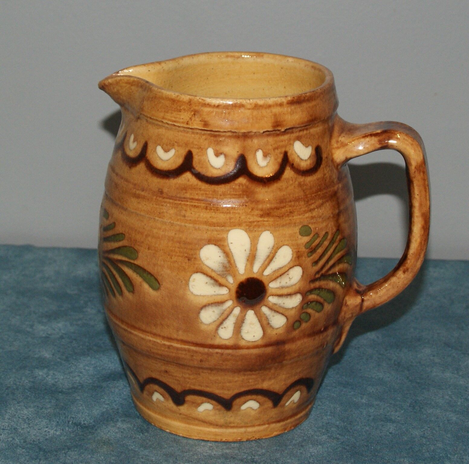 Glazed terracotta pitcher decorated with friezes and flowers