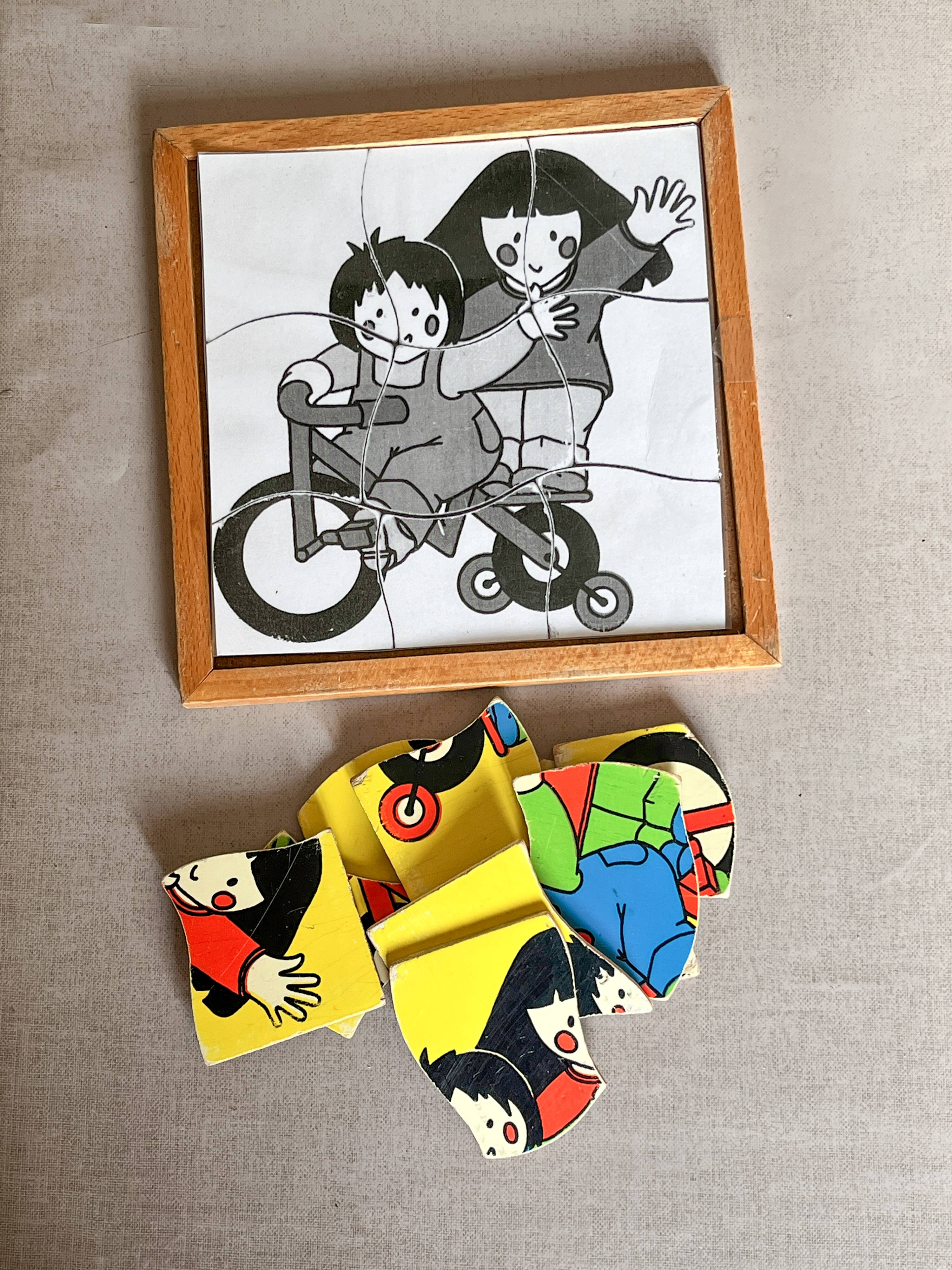 Wooden frame puzzle from the 60s/70s depicting two children on bicycles.