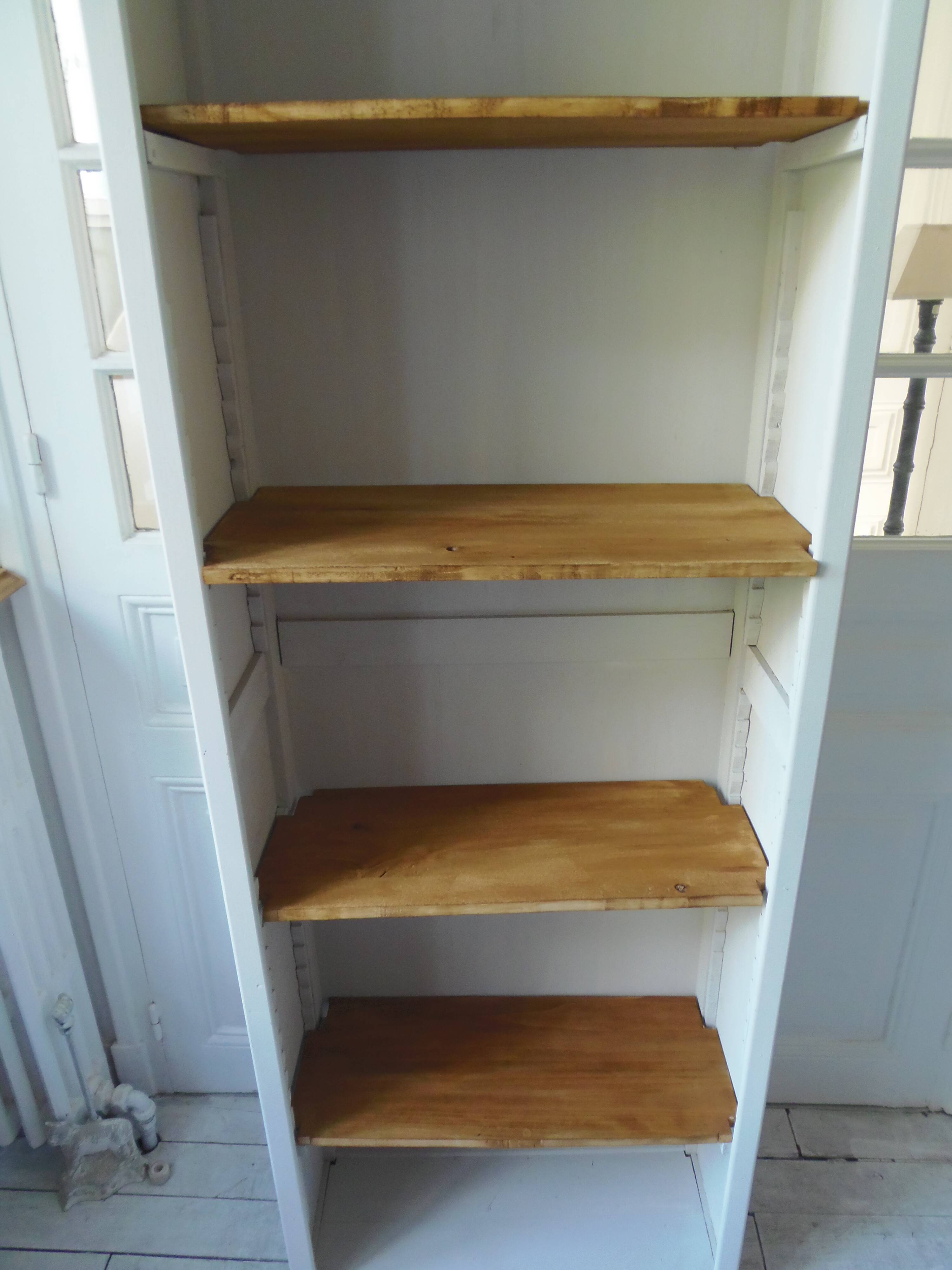 Shallow depth bookcase re-enchanted in pearl gray, wooden shelves.